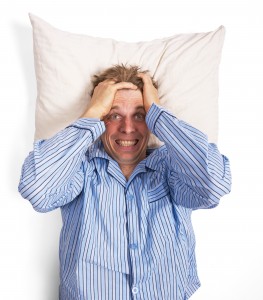 Frustrated or angry man in bed awake